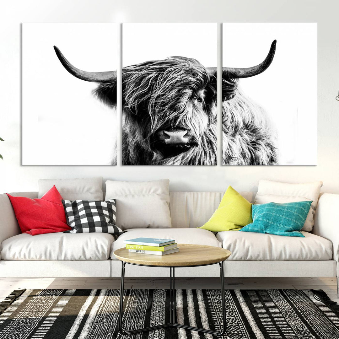 The Scottish Highland Cow Cattle Art Print Farmhouse Wall Art Canvas Print enhances rustic farmhouse decor with its depiction of a long-haired, large-horned cow. This triptych is an ideal choice for chic wall art.