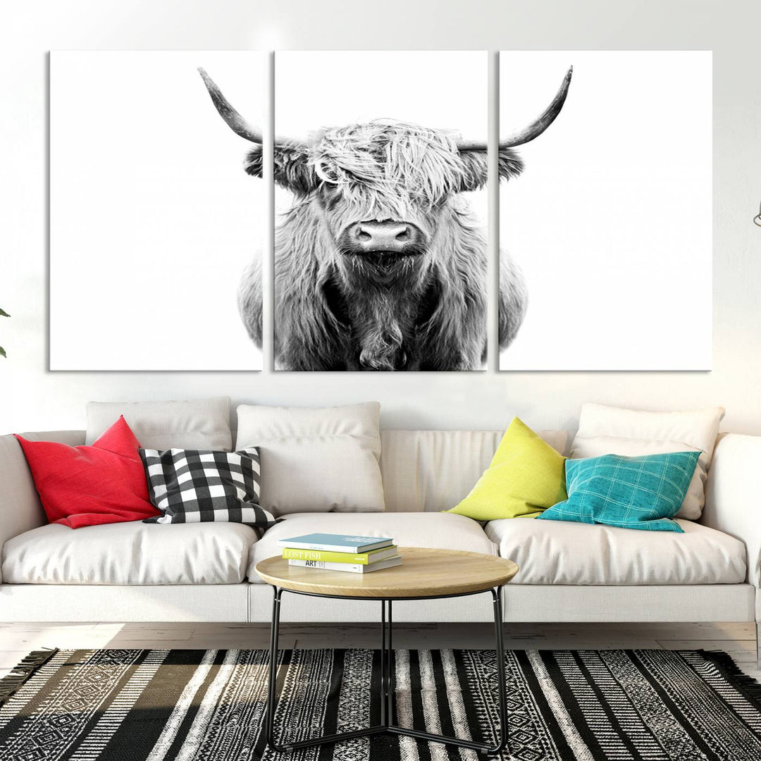 The wall art features a triptych of a Scottish Highland cow, printed on museum-quality canvases with a UV-protective coating. This decorative piece is known as the Highland Cow Canvas Wall Art Farm House Wall Art.