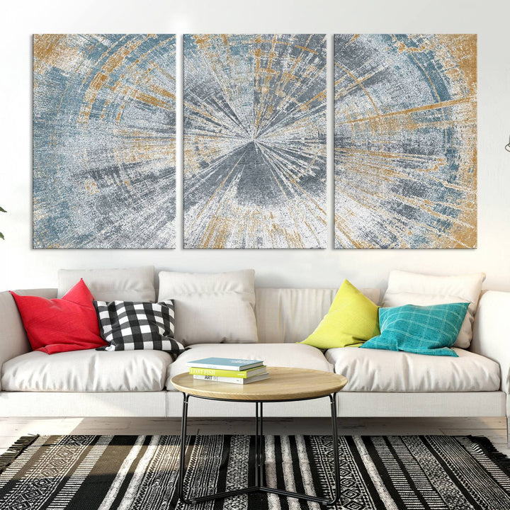 The Radiant Abstract Wood Rings Canvas Art, a modern triptych wall decor, enhances the contemporary style of the living room with its blue, white, and gold hues.