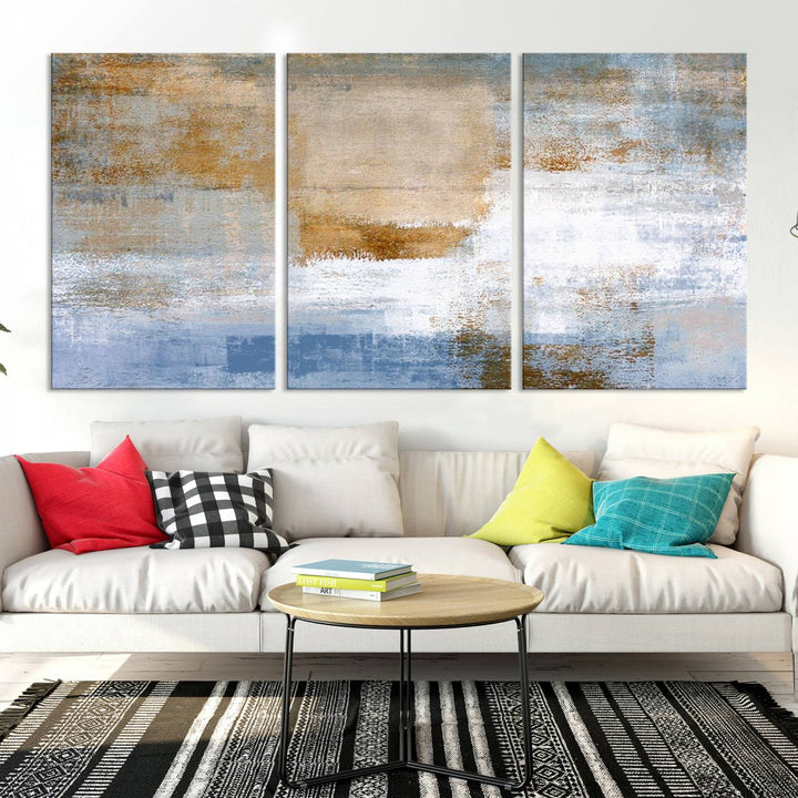 The Blue Multi Panel Abstract Wall Art Canvas Print, featuring an elegant blend of blue, beige, and brown tones, hangs gracefully on the wall, adding a contemporary touch to the space.