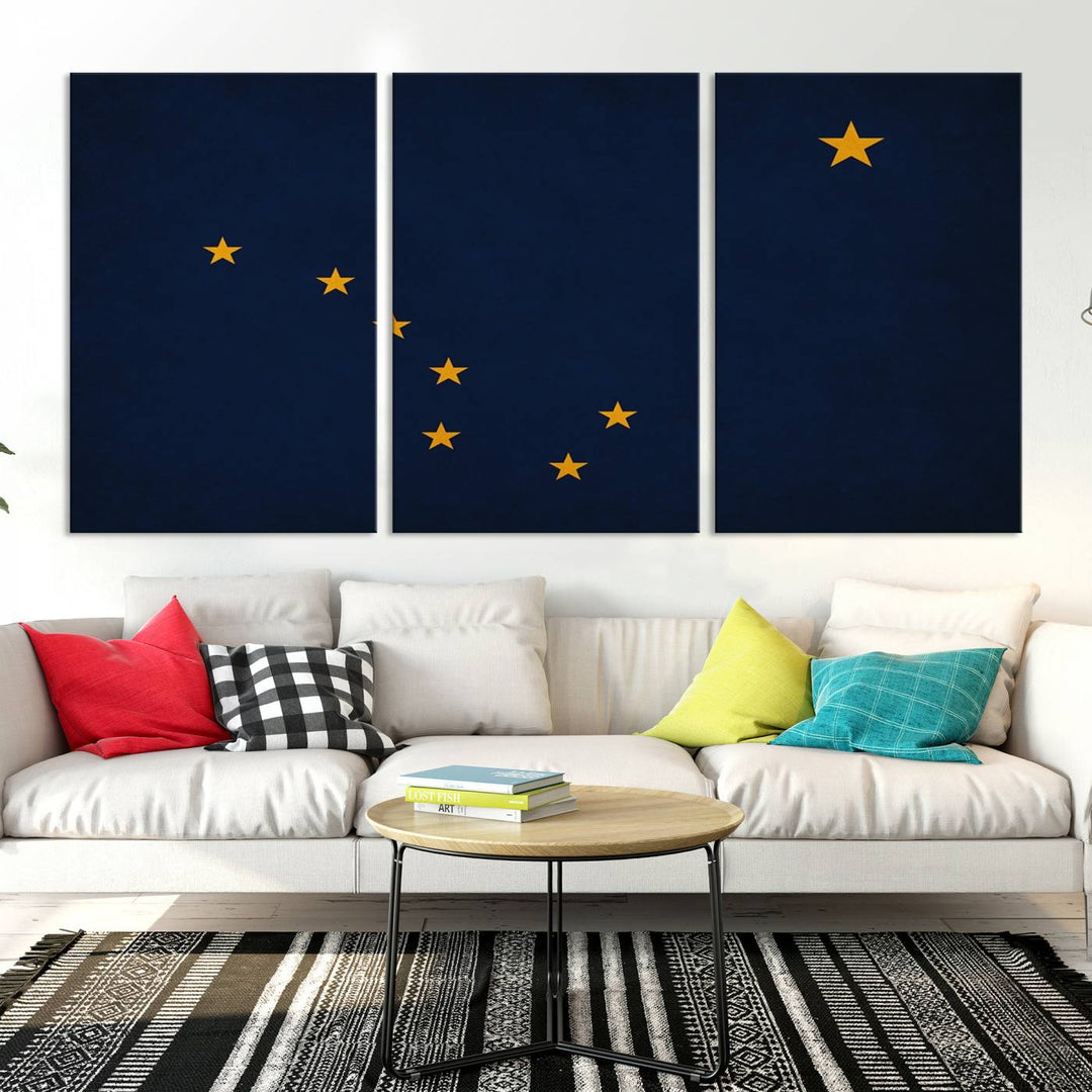 A contemporary living room featuring a triptych artwork of stars on a navy background, accentuated by the striking Alaska States Flag Wall Art Canvas Print.