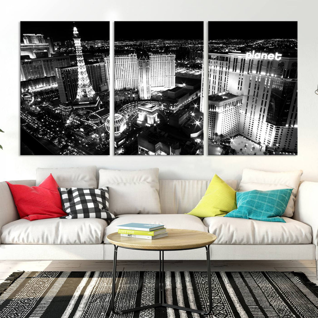 The Las Vegas Wall Art Canvas Print is a black and white triptych that showcases a city skyline at night. Crafted on museum-quality canvas with a UV-protective coating, it serves as an elegant and ready-to-hang focal point in the room.