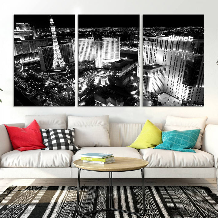 The Las Vegas Wall Art Canvas Print is a black and white triptych that showcases a city skyline at night. Crafted on museum-quality canvas with a UV-protective coating, it serves as an elegant and ready-to-hang focal point in the room.