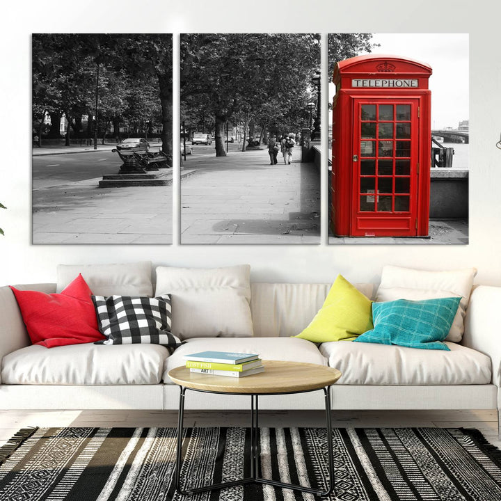 The London Phone Club Wall Art is a stunning piece that showcases a red telephone box set in a black and white street scene on museum-quality canvas. It is gallery wrapped with a UV-protective coating to preserve its vibrant charm.