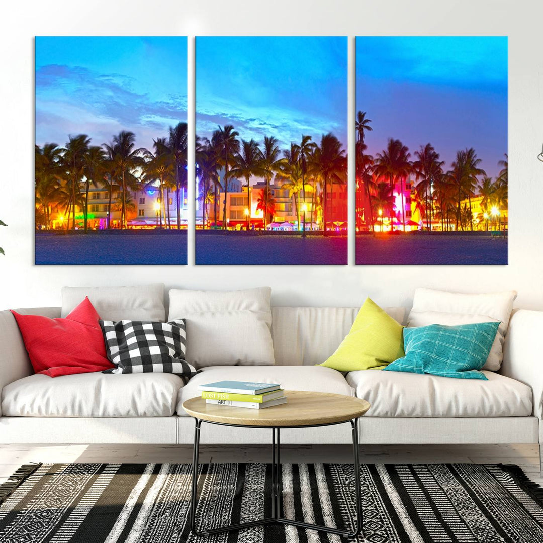 The living room features a three-panel Miami City Wall Art Canvas Print, showcasing a colorful, illuminated beach scene with palm trees on museum-quality canvas.