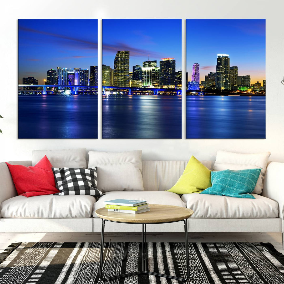 The modern living room showcases a striking Miami Blue Night Wall Art canvas print on the wall. The artwork is gallery wrapped on museum-quality canvas, ensuring durability and elegance.