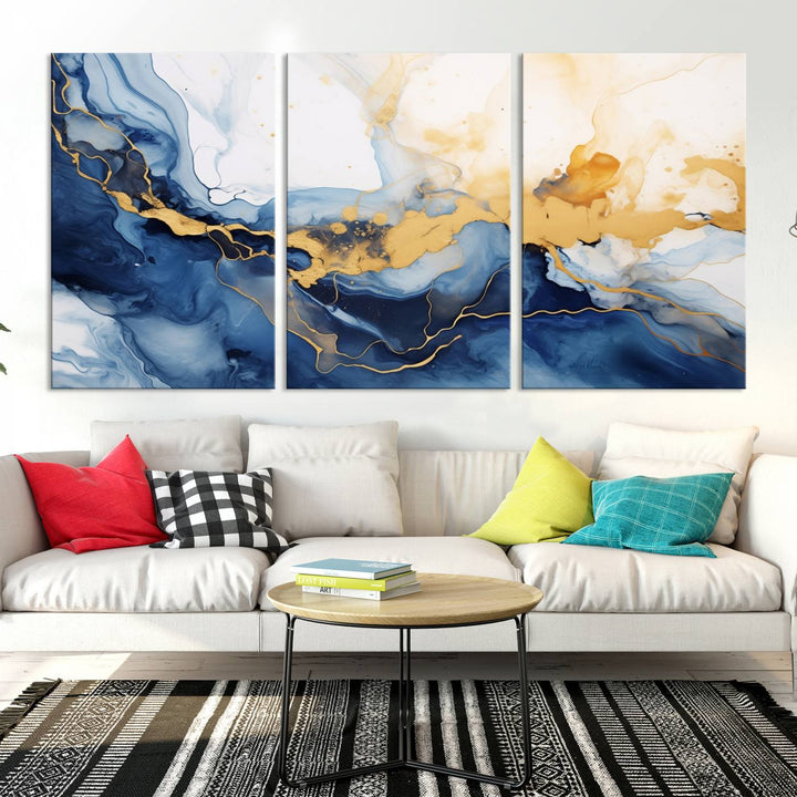 A contemporary living room featuring the "Navy Blue Gold Abstract Wall Art Canvas Print" on the wall, displayed on a gallery-wrapped, museum-quality canvas.