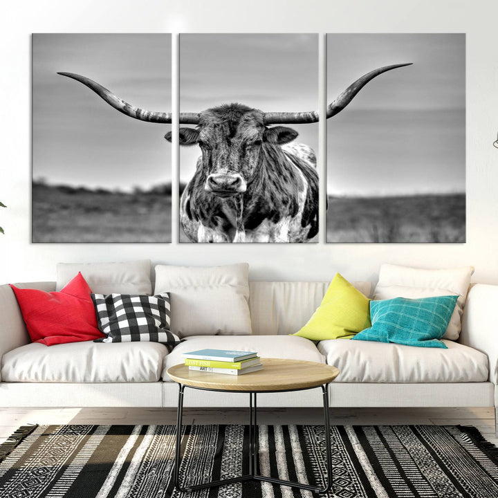 The Texas Longhorn Cow Wall Art, featuring a black and white image of a longhorn bull on canvas, brings charm to the room with its sophisticated appeal.