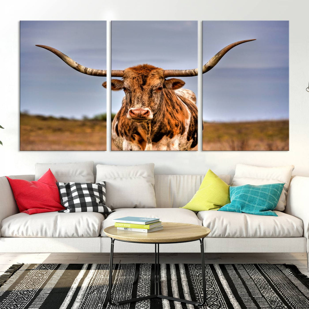 The Texas Longhorn Wall Art Print, a triptych canvas artwork depicting a longhorn bull in a field, features a gallery-quality finish.