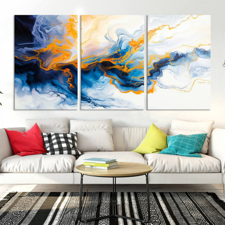 A stunning Fluid Alcohol Ink Wall Art with Gold Wall Art Canvas Print, featuring vibrant blue, orange, and white swirls, adorns the wall. This gallery-quality finish adds an exquisite touch to any living space.