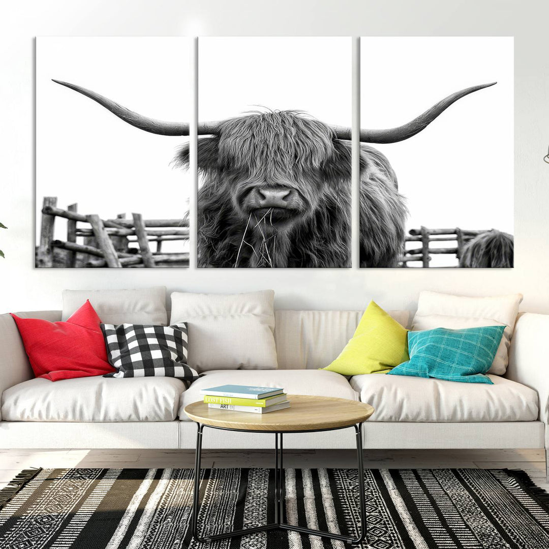 The Longhorn Canvas Print, featuring a black-and-white triptych of a Bighorn cow with shaggy fur and impressive long horns, is elegantly showcased. This wall art piece boasts a gallery-quality finish on premium canvas, bringing sophistication to any room.