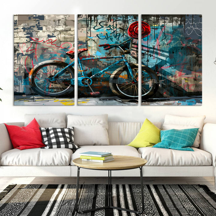 A modern living room features a triptych wall art of an abstract bicycle, designed in a graffiti style on a brick wall. This piece is expertly crafted on the Abstract Bicycle Wall Art Canvas Print, offering a premium canvas that ensures a gallery-quality finish.