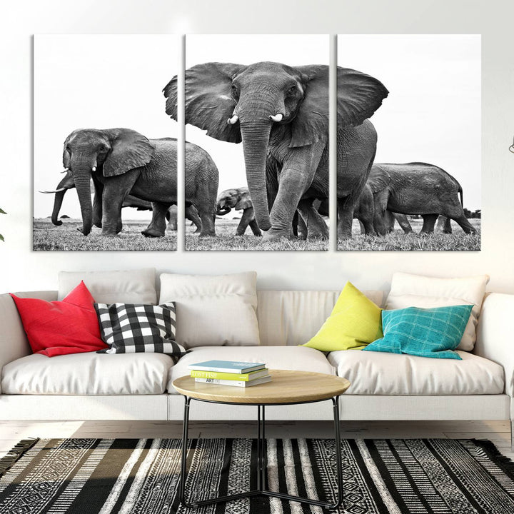 The Black White Elephant Family Wall Art Canvas Print features a triptych of elephants walking in the wild, crafted as gallery-quality wall art on premium canvas.