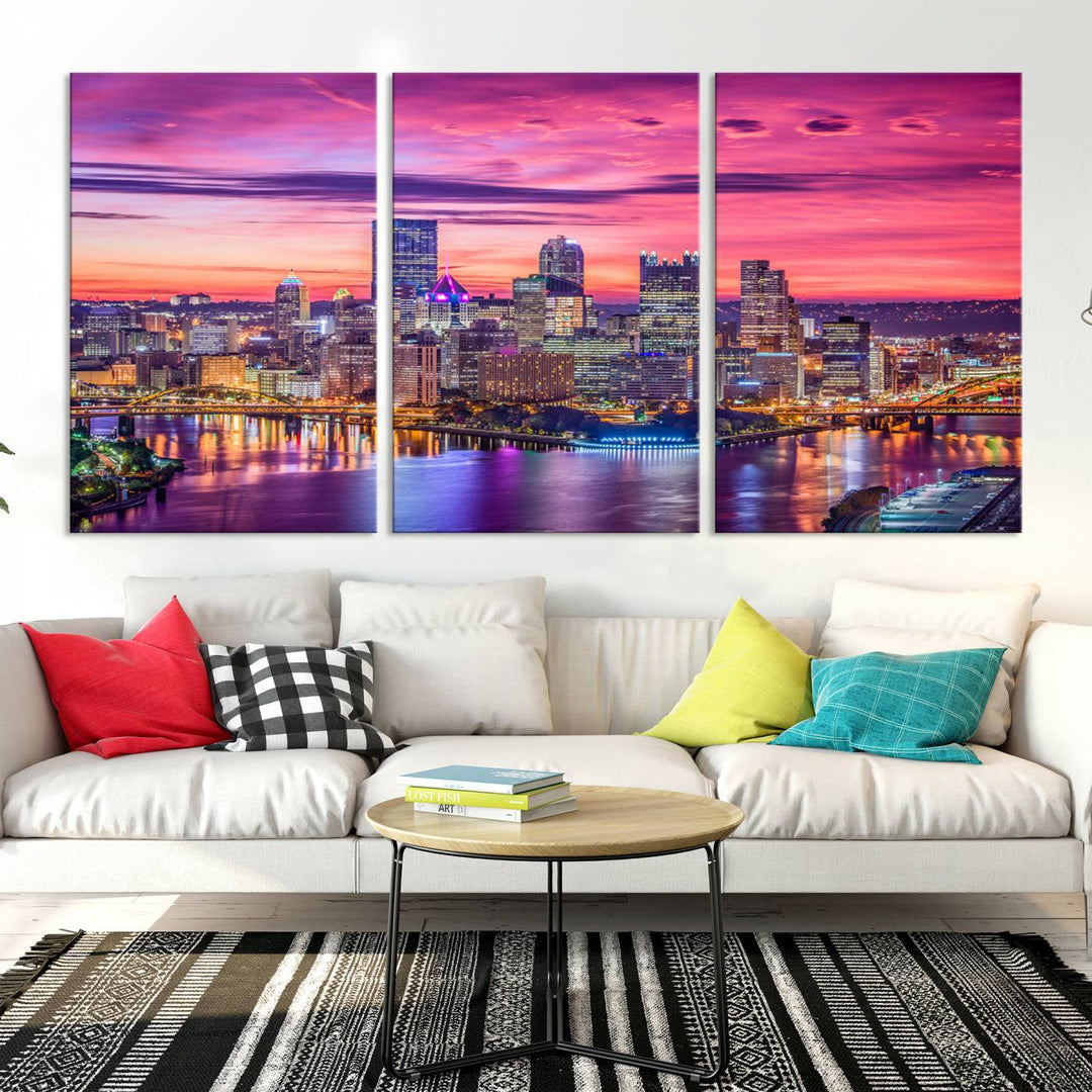 The Pittsburg Wall Art Canvas Print, showcasing a vibrant sunset glow over the city skyline and crafted by a professional artisan, adorns the space.