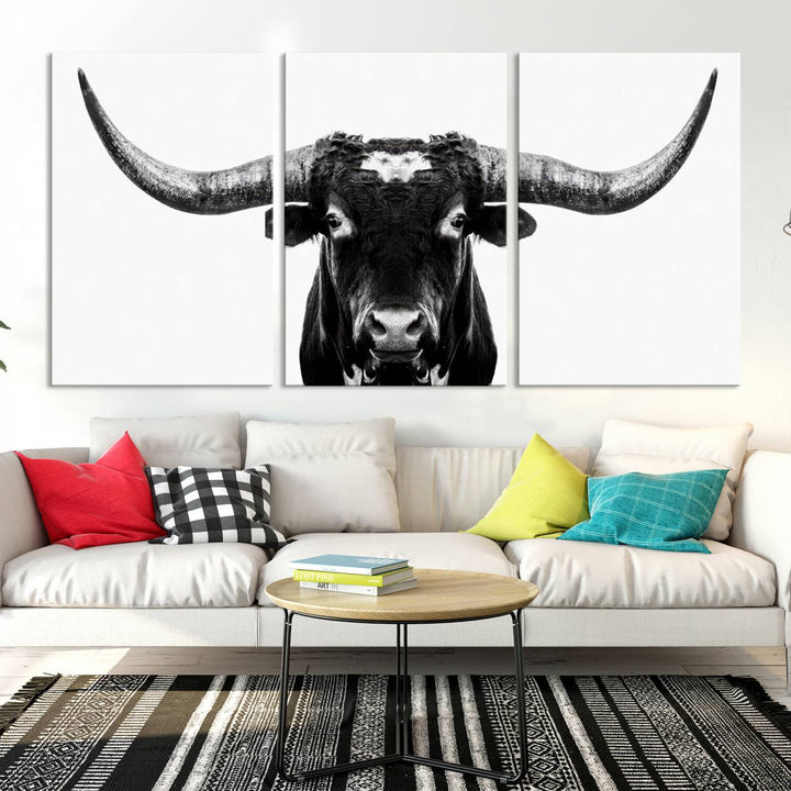 The living room is adorned with the Texas Cow Longhorn Wall Art Canvas Print in Black and White—framed and ready to hang.