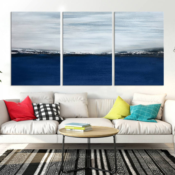 The modern living room is enhanced by the Navy Blue Abstract Wall Art Canvas Print on the wall, crafted as handmade wall art with a gallery-quality finish.