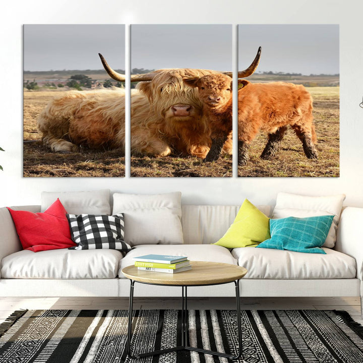 The three-panel canvas artwork, titled "Highland Cow Canvas Wall Art Animal Print for Farm House Decor," features a serene scene of a resting Highland cow and calf in a field. The piece highlights its gallery-quality finish.