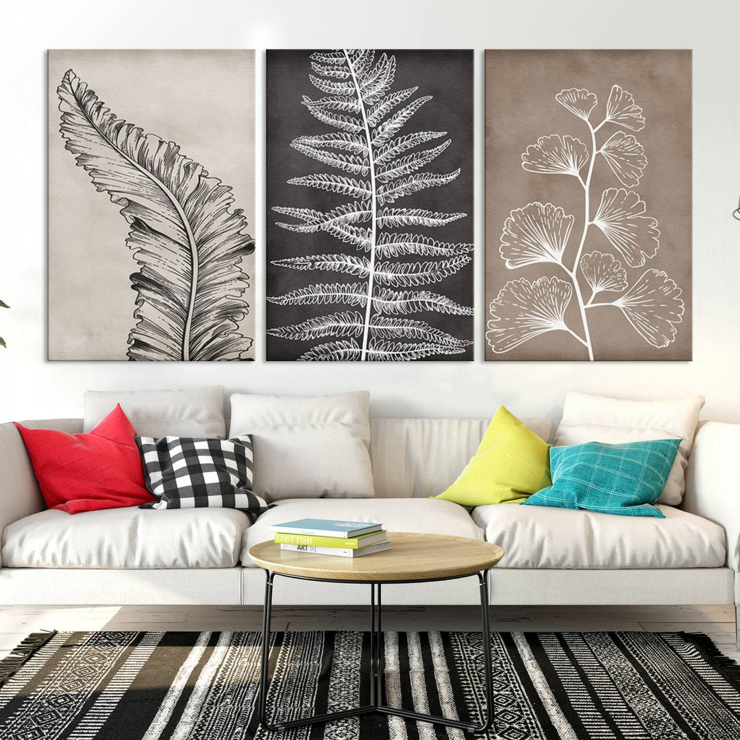 The Botanical Leaf Art Collection - 3-Panel Wall Art Canvas Print is framed above a modern console table.