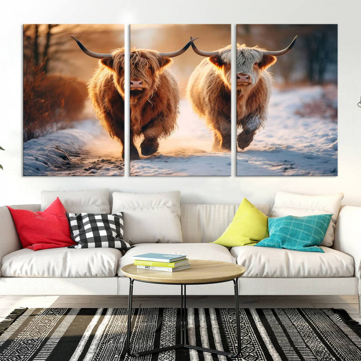 The living room showcases a triptych from the Scottish Highland Cow Horn Farm Wall Art Canvas Print collection, depicting two Highland cows running in the snow. Complementing this are handmade wall art pieces with a gallery-quality finish that add an elegant touch.