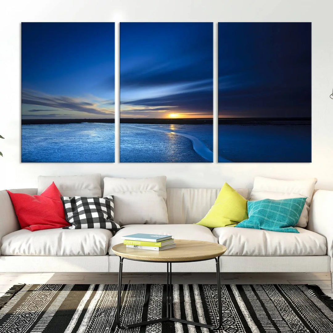 The living room features a triptych of the Wall Art Canvas Print Navy Sunset Lake Landscape Artwork, adding to its tranquil vibe.