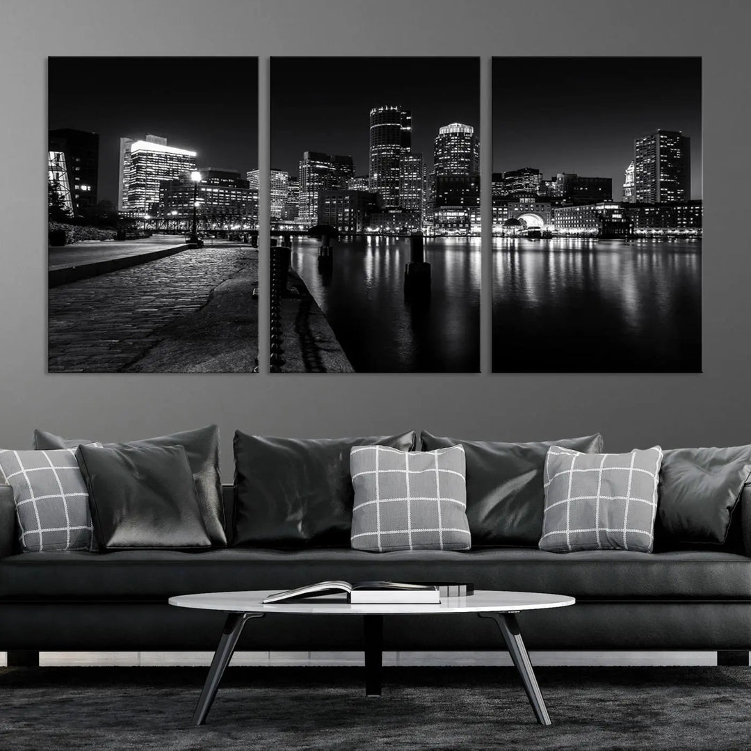 The Boston City Lights Skyline Black and White Wall Art Cityscape Canvas Print portrays a triptych of the city skyline at night reflecting on a calm river. This museum-quality canvas features UV-protective finishes to preserve its timeless allure.