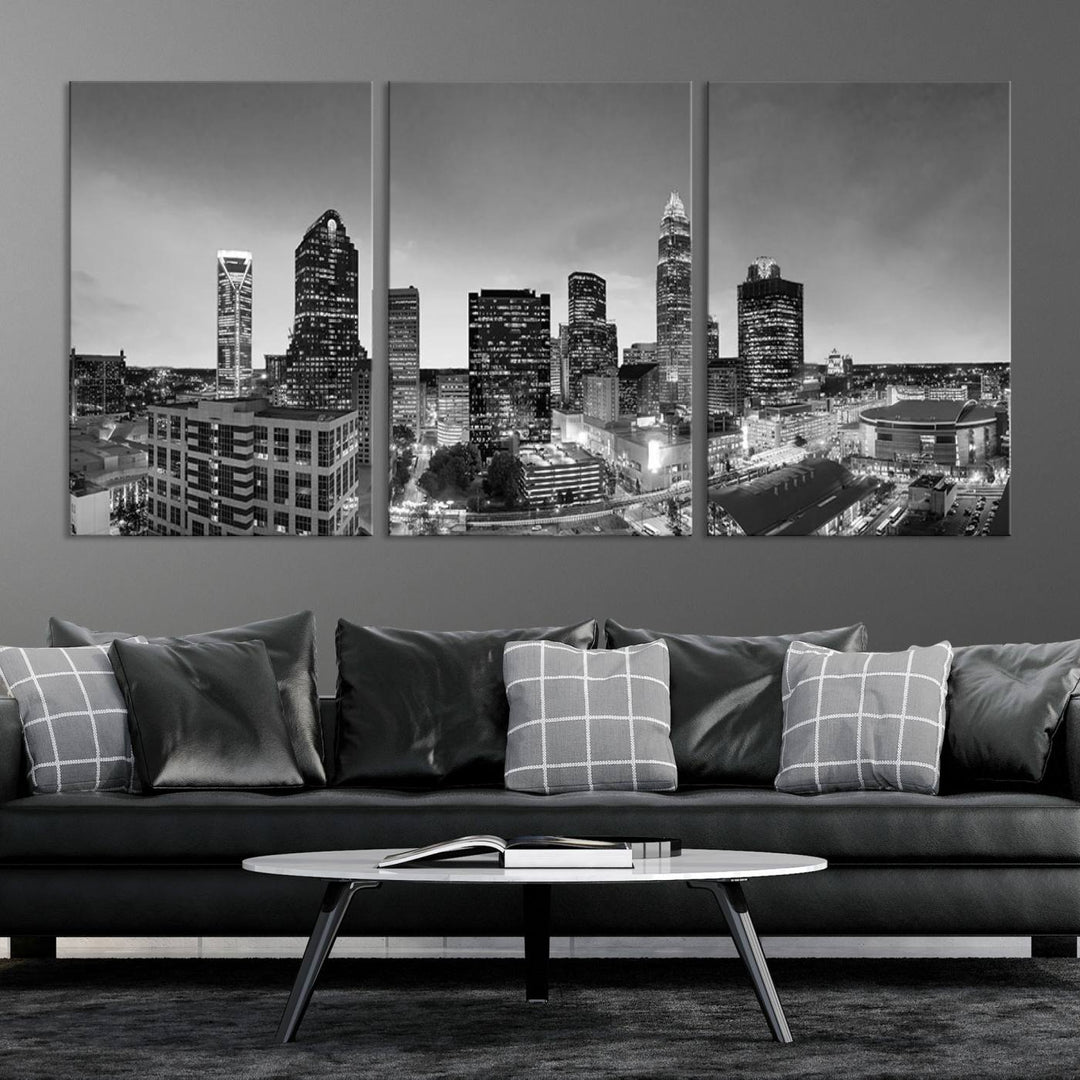 The "Charlotte City Cloudy Skyline Black and White Wall Art Cityscape Canvas Print" hangs on a dark wall, showcasing its UV-protective properties for enduring beauty.