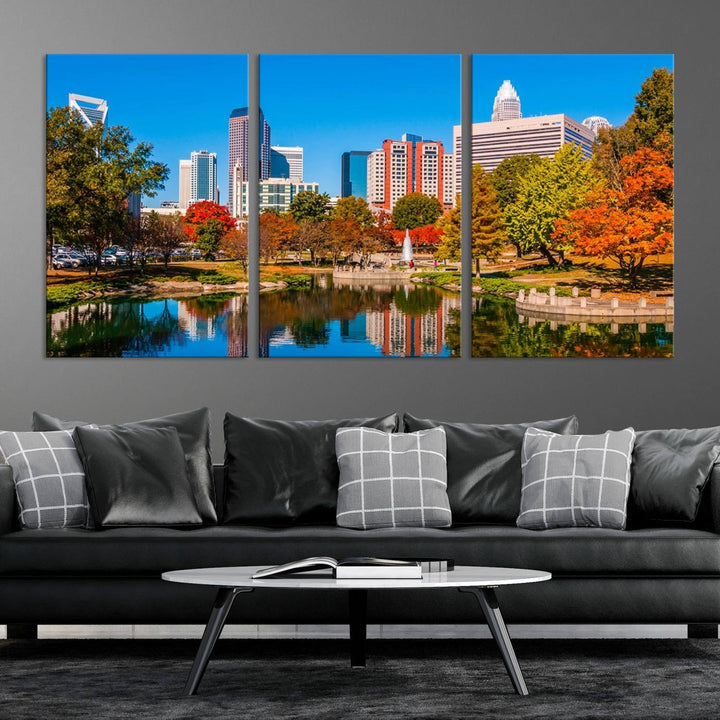 The Charlotte City Park at Fall Skyline Cityscape View wall art canvas print features a city panorama with a park and lake accented by autumn trees. It is mounted on museum-quality canvas with UV-protective coating and decorates the space.