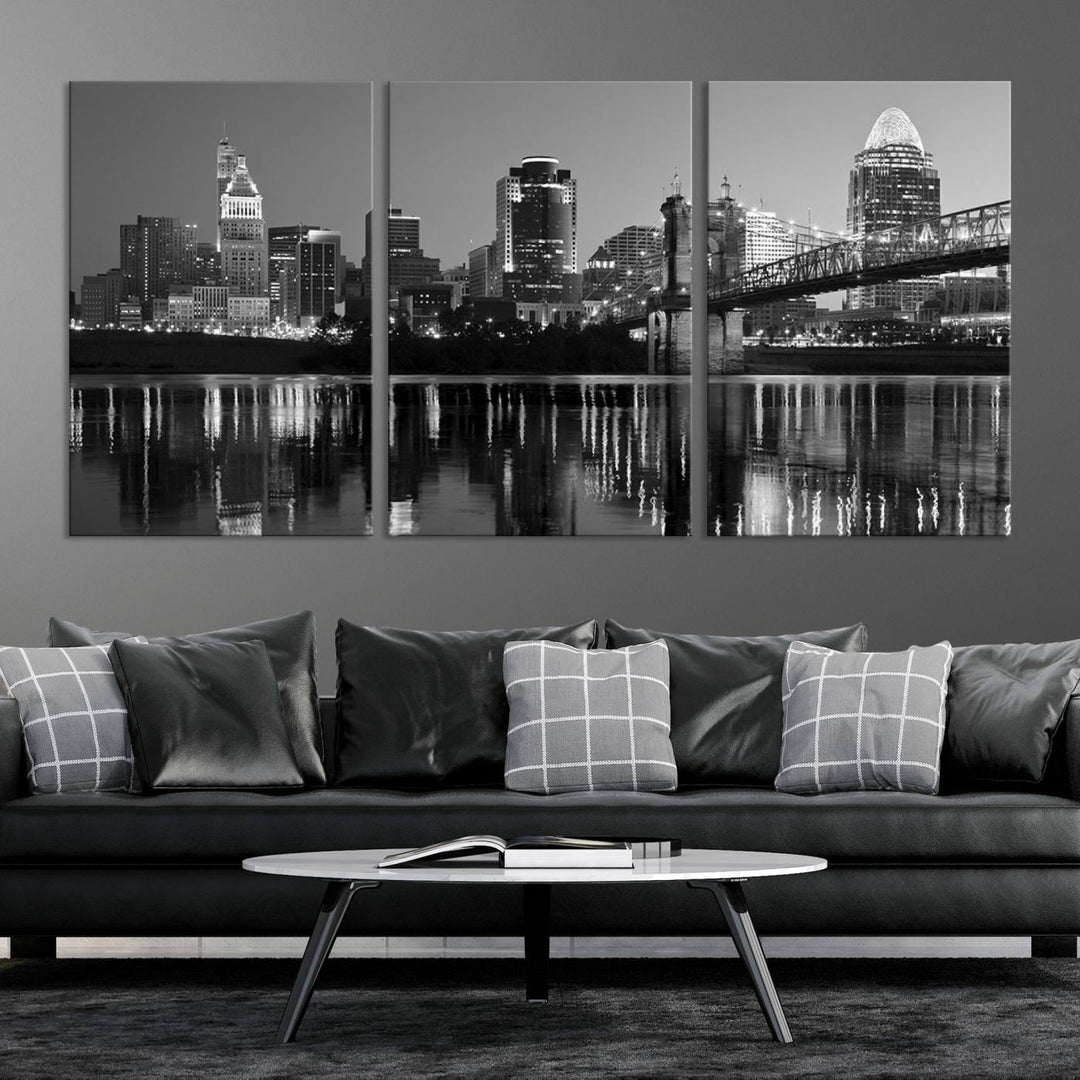 The wall showcases a ready-to-hang triptych of the Cincinnati City Lights Skyline in black and white, printed on museum-quality canvas.