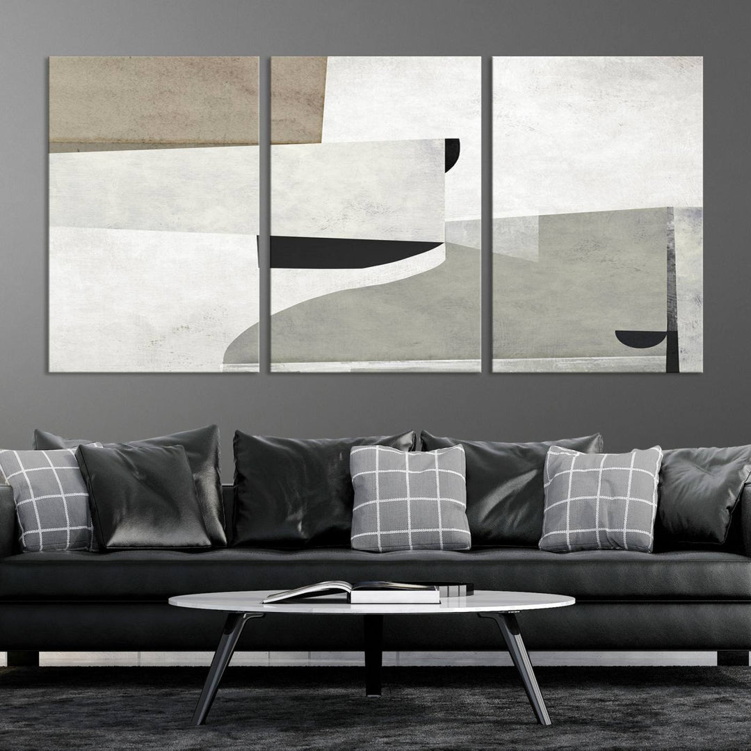 The Brown Gray Figures Abstract Wall Art Canvas Print is displayed as a triptych on a dark wall. The piece is gallery wrapped, offering a seamless finish and enhanced durability due to its UV-protective coating.