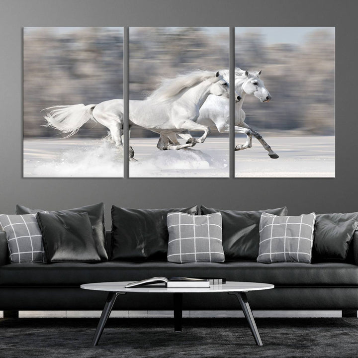 The "All The White Horses Wall Art Canvas Print" depicts a triptych of galloping white horses across a snowy landscape. These museum-quality canvases come with a UV-protective coating to maintain their stunning appearance over time.