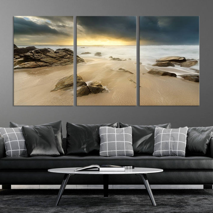 A gallery-wrapped, three-panel artwork titled "Rocks and Waves Wall Art Canvas Print" depicts a rocky beach at sunset. Each canvas showcases museum-quality craftsmanship and a UV-protective coating to maintain its vibrant colors.