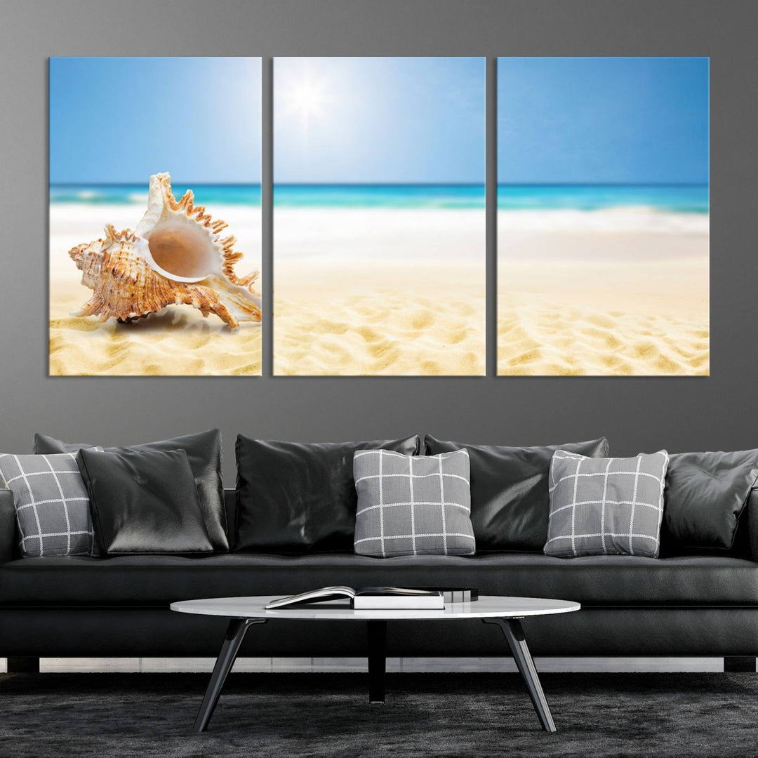 The Sea Shell on The Beach Sun Sand Wall Art Canvas Print is a triptych that beautifully captures a beach scene with a large seashell on the sand.