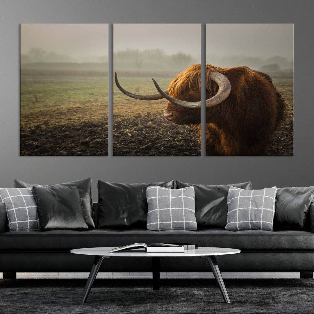 The "Big Cow Horn Wall Art Canvas Print" is a hand-assembled framed canvas depicting a Highland cow in a misty field. It is crafted with a UV-protective coating to ensure lasting vibrancy.