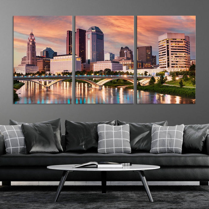 The "Columbus City Lights Sunset Orange Cloudy Skyline Cityscape View" wall art is featured on the wall. This triptych is printed on museum-quality canvas and includes a UV-protective coating, ensuring lasting vibrancy.