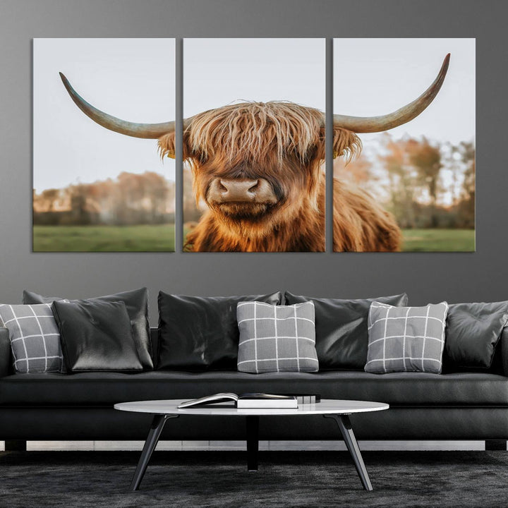 A Highland Cow Animal Scottish Cattle Art Print Farmhouse Wall Art Canvas Print hangs in the living room, adding a touch of rustic farmhouse decor.