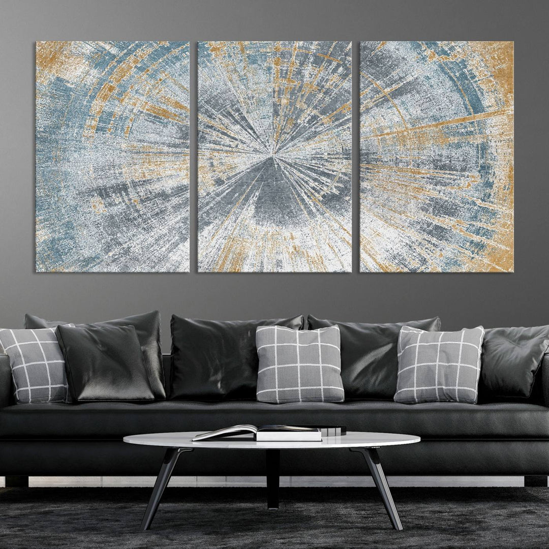 The Radiant Abstract Wood Rings Canvas Art, a modern triptych wall decor, enhances the contemporary style of the living room with its blue, white, and gold hues.