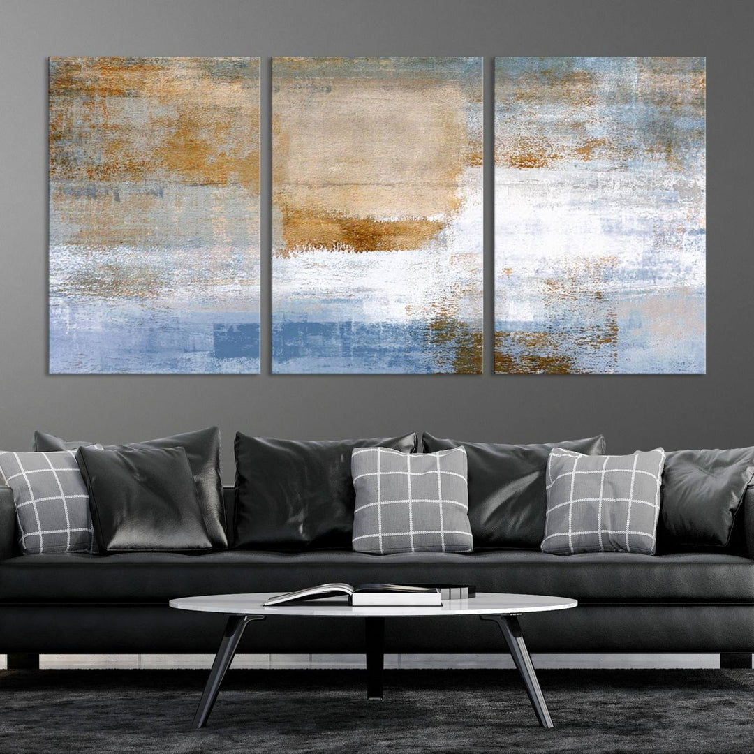 The Blue Multi Panel Abstract Wall Art Canvas Print, featuring an elegant blend of blue, beige, and brown tones, hangs gracefully on the wall, adding a contemporary touch to the space.