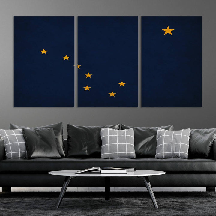 A contemporary living room featuring a triptych artwork of stars on a navy background, accentuated by the striking Alaska States Flag Wall Art Canvas Print.