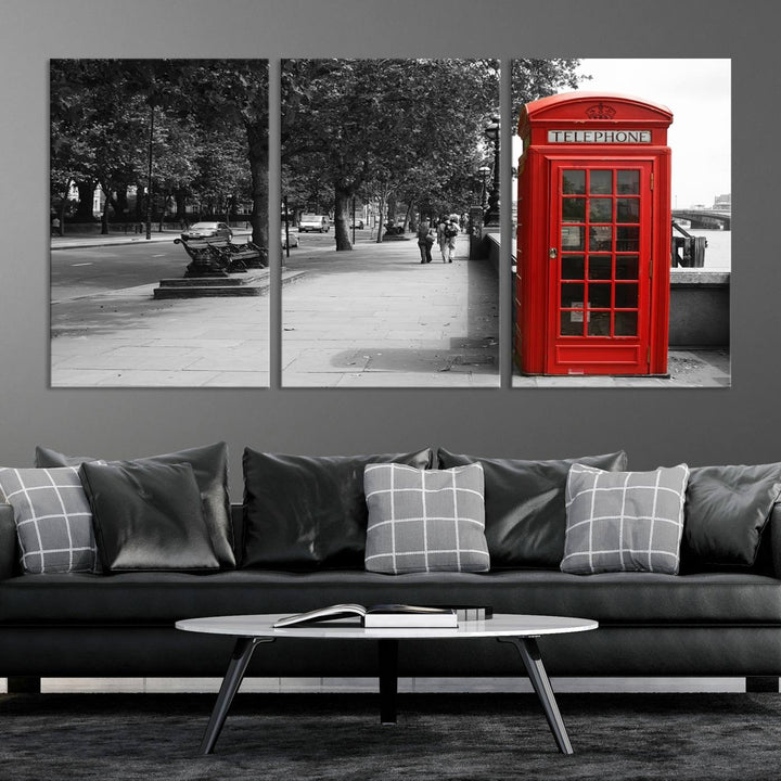 The London Phone Club Wall Art is a stunning piece that showcases a red telephone box set in a black and white street scene on museum-quality canvas. It is gallery wrapped with a UV-protective coating to preserve its vibrant charm.