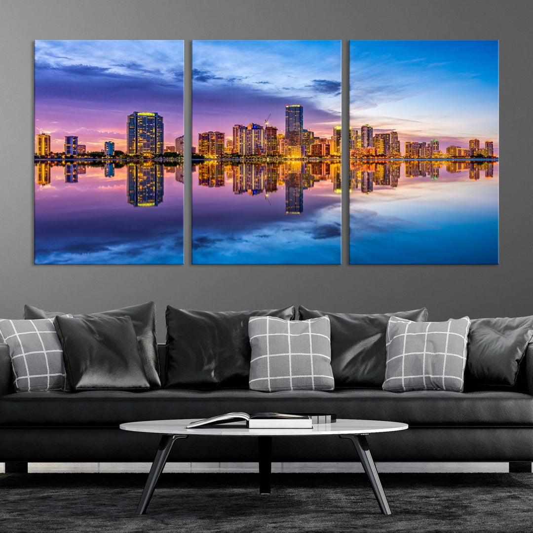 The Miami City Wall Art Canvas Print, featuring a three-panel depiction of a city skyline at sunset reflected in water, beautifully enhances the wall. Made with museum-quality canvas and a UV-protective coating, it comes ready to hang.