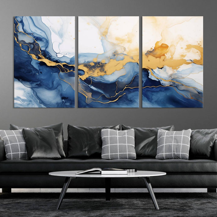 A contemporary living room featuring the "Navy Blue Gold Abstract Wall Art Canvas Print" on the wall, displayed on a gallery-wrapped, museum-quality canvas.