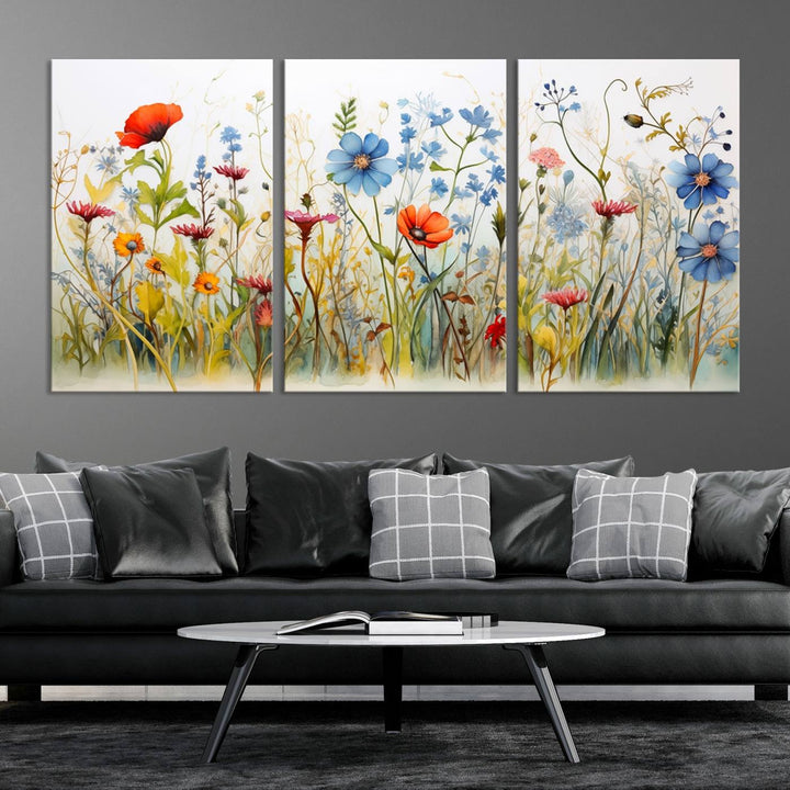 The Colorful Wildflower Canvas Wall Art – Vibrant Floral Botanical Print, consisting of a large 3 panel set, adds bright nature decor to the living room against a black wall.