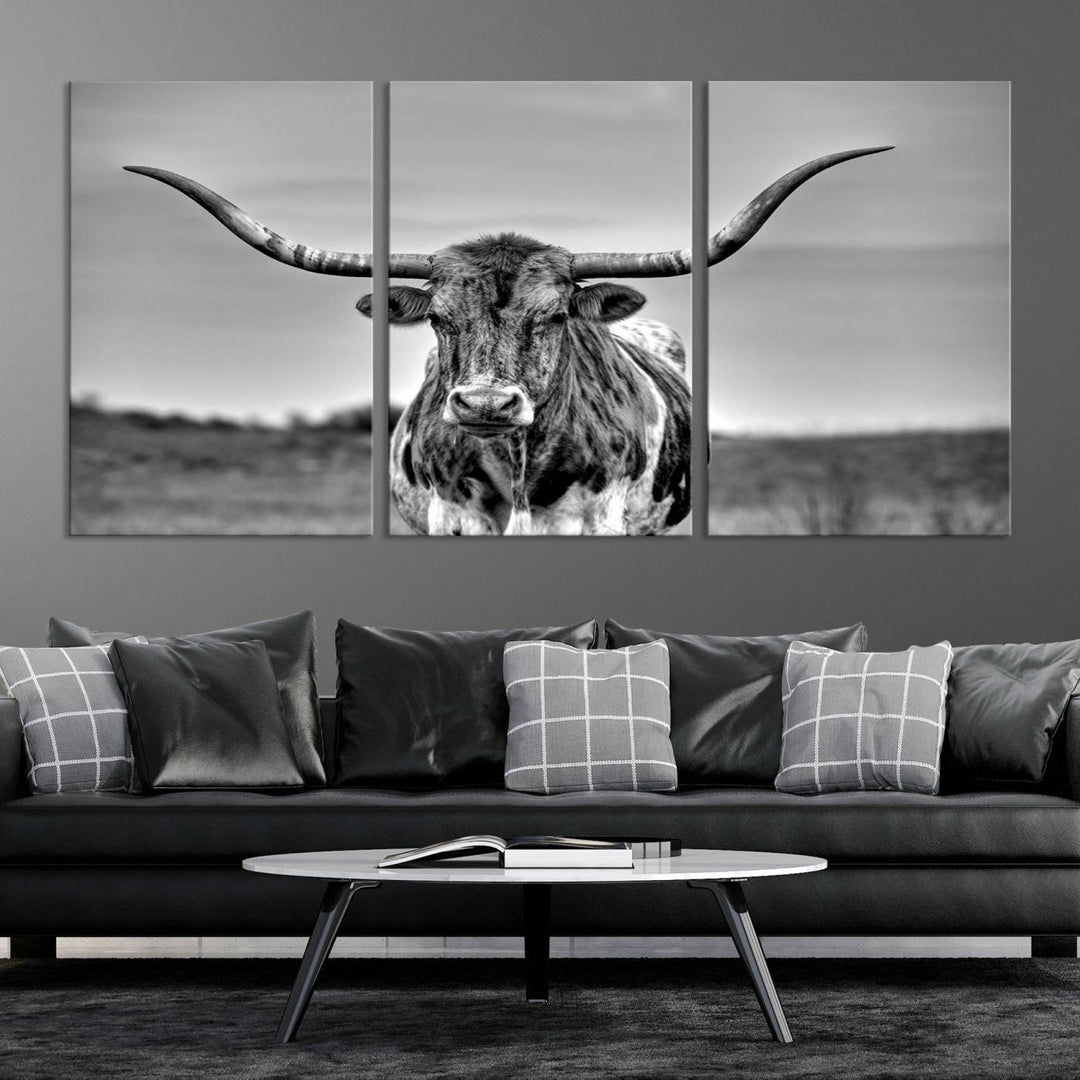 The Texas Longhorn Cow Wall Art, featuring a black and white image of a longhorn bull on canvas, brings charm to the room with its sophisticated appeal.