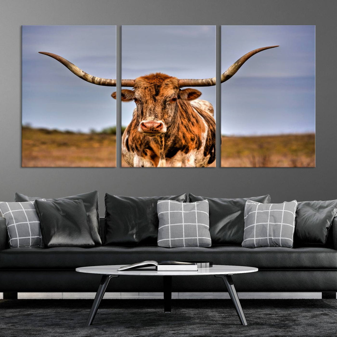 The Texas Longhorn Wall Art Print, a triptych canvas artwork depicting a longhorn bull in a field, features a gallery-quality finish.