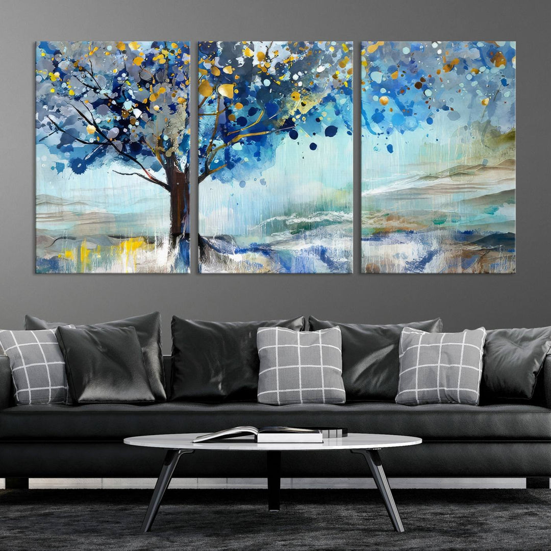 A modern living room features a three-panel Watercolor Style Abstract Tree Printing Wall Art Canvas in vibrant blue and yellow, crafted on museum-quality material.