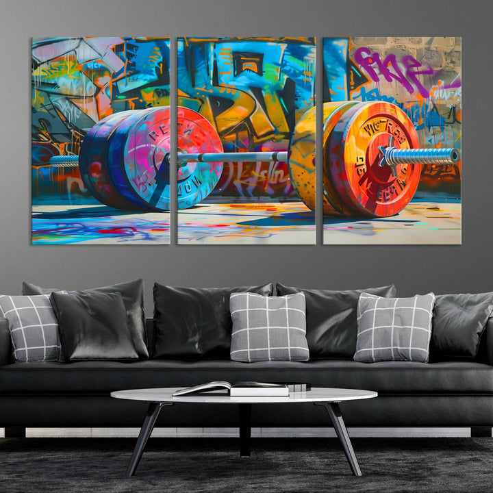 The Fitness Gym Barbell Graffiti Wall Art Canvas Print, a vibrant triptych featuring a barbell against a graffiti backdrop, elegantly hangs in the room. Crafted on premium canvas with a gallery-quality finish, this stunning piece of wall art effortlessly combines urban flair with sophisticated decor.