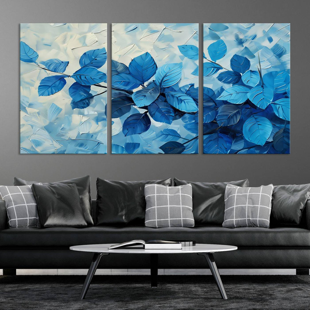 The contemporary living room is highlighted by the Abstract Blue Leaf Wall Art Canvas Print on the wall. The hand-assembled framed art enhances the room's vibrant decor, crafting a gallery-worthy ambience.