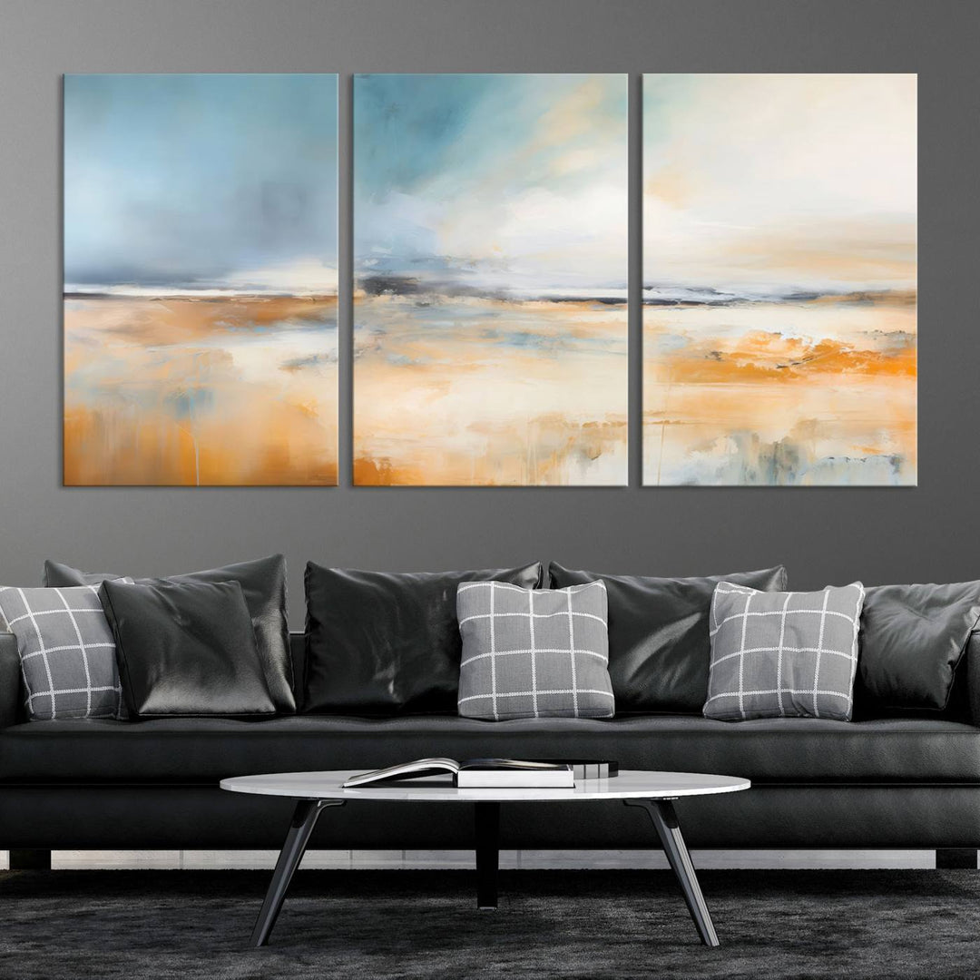 The Abstract Landscape Wall Art Canvas Print, featuring warm tones of orange and blue, is displayed on a dark wall.