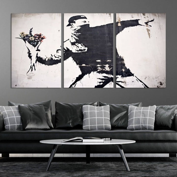 The living room features a split-panel art piece named "Banksy Flower Throw Graffiti Street Wall Art Canvas Print," gallery wrapped on museum-quality polycotton canvas and accentuated by modern decor elements.