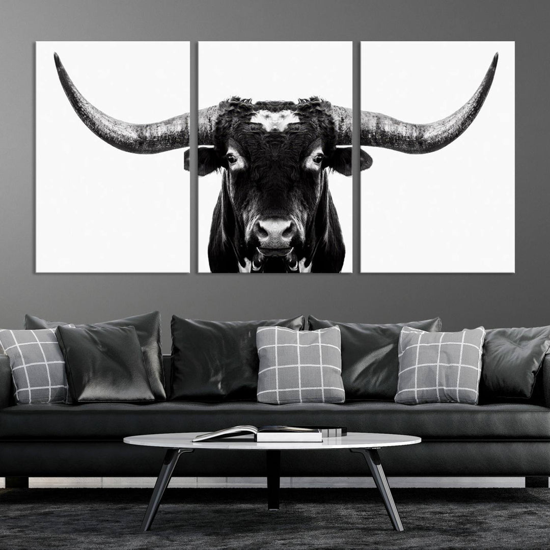 The living room is adorned with the Texas Cow Longhorn Wall Art Canvas Print in Black and White—framed and ready to hang.